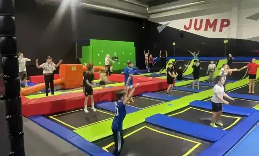 uczniowie klas czwartych skaczą na trampolinach 